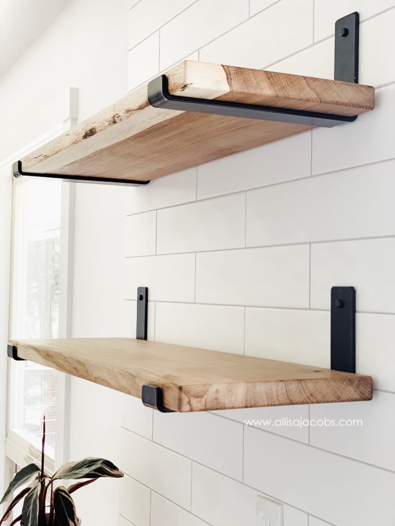 white oak wood shelves with balck metal shelf brackets on white kitchen tile - © allisa jacobs design