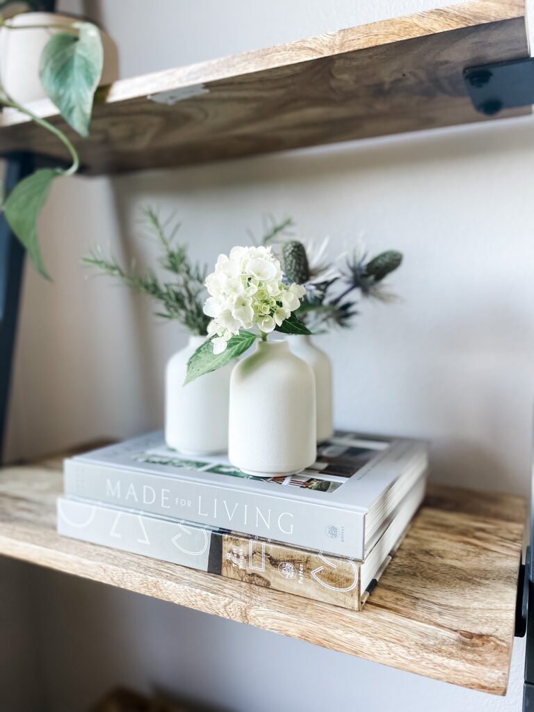 amazon vases on shelf with books