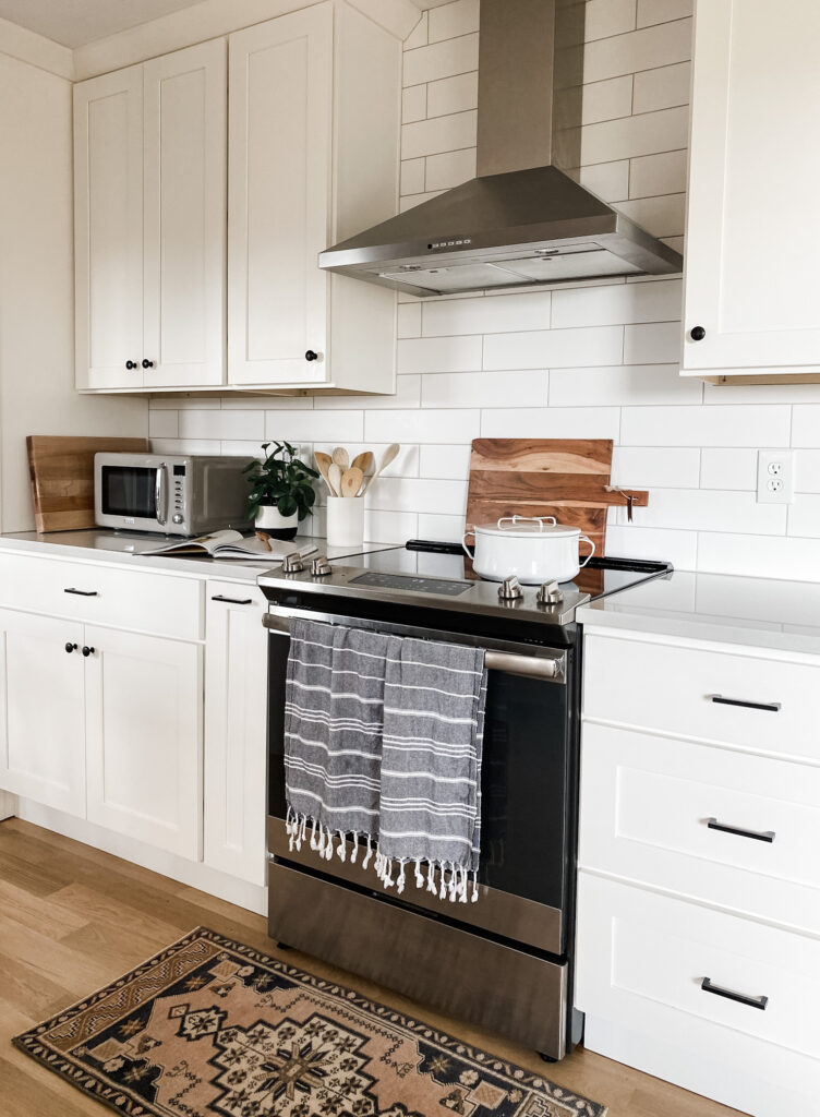 white kitchen with stove and decor