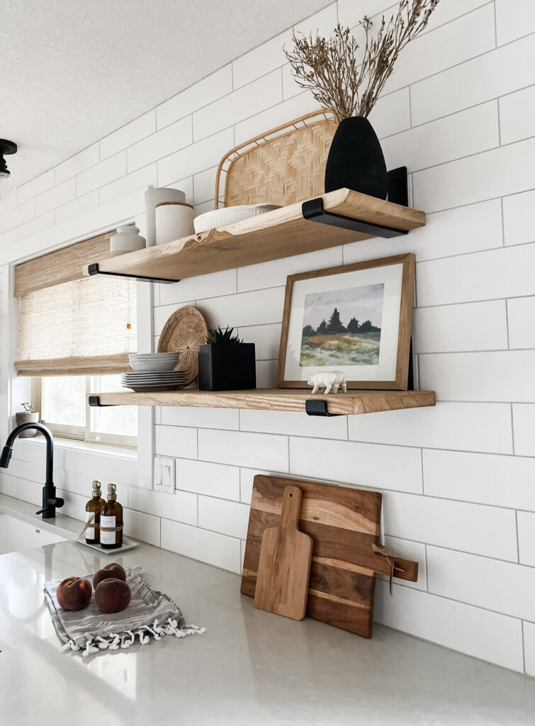 kitchen shelving styled with landscape art print