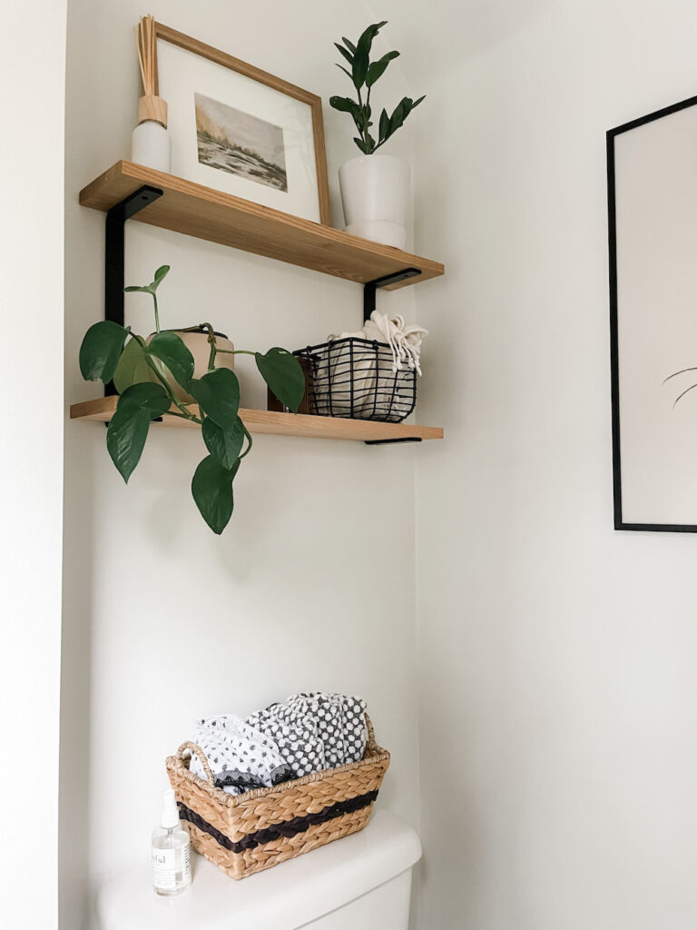 wood shelves above toilet in bathroom