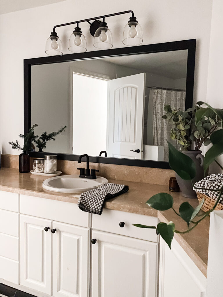 neutral updated bathroom with framed mirror