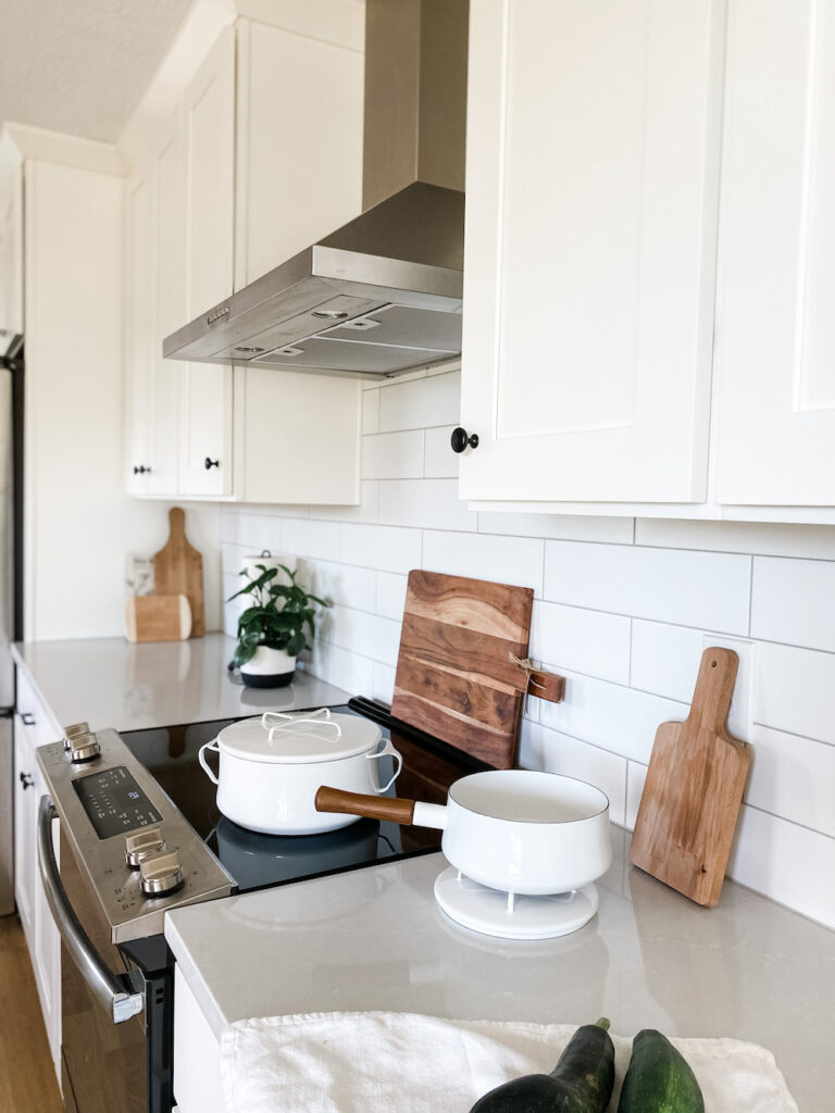 white kitchen with white pots and pans