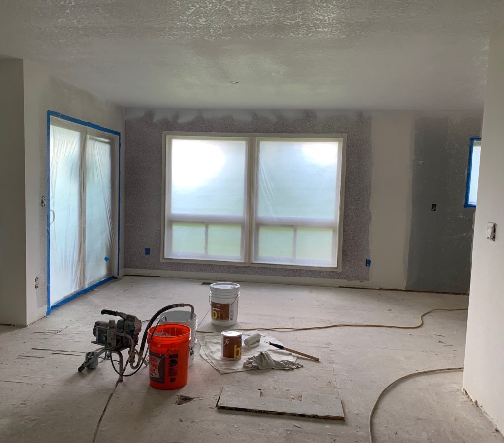 spraying the room with one of the best wall paints, Benjamin Moore Chantilly Lace
