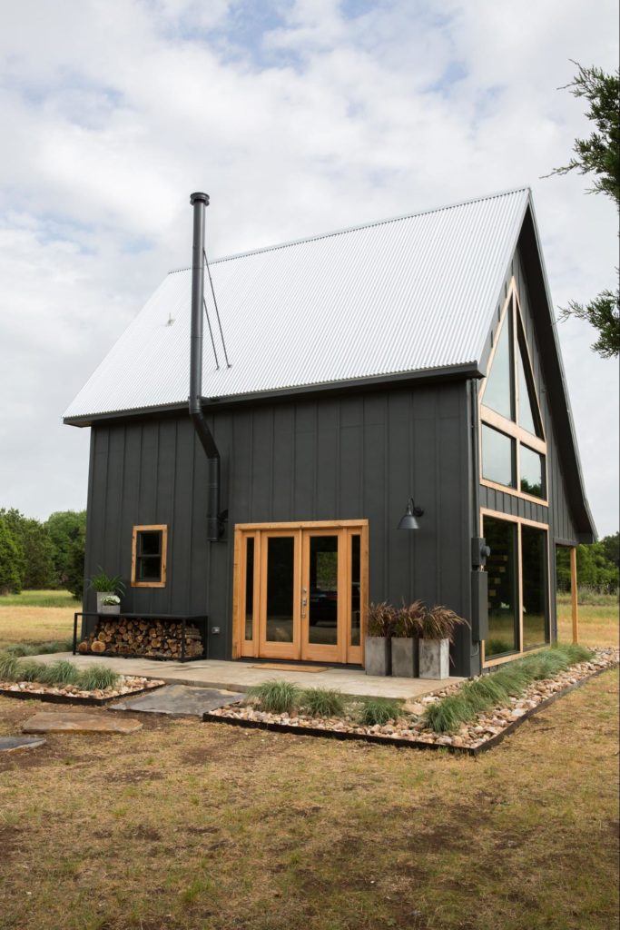 modern cabin with black house paint with natural accents
