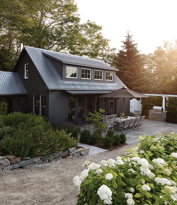 gorgeous dark gray house with landscaping 