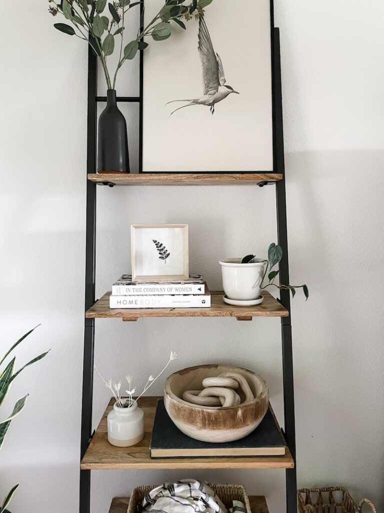 bookshelf with neutral home decor