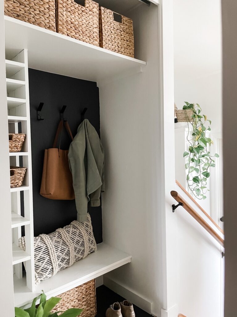 hall closet makeover with hooks, baskets, and removed door