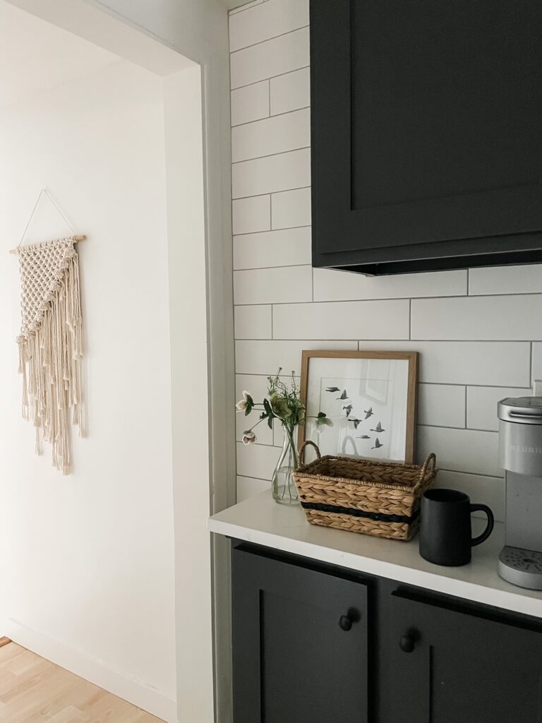 kitchen coffee nook with artwork, baskets, and flowers