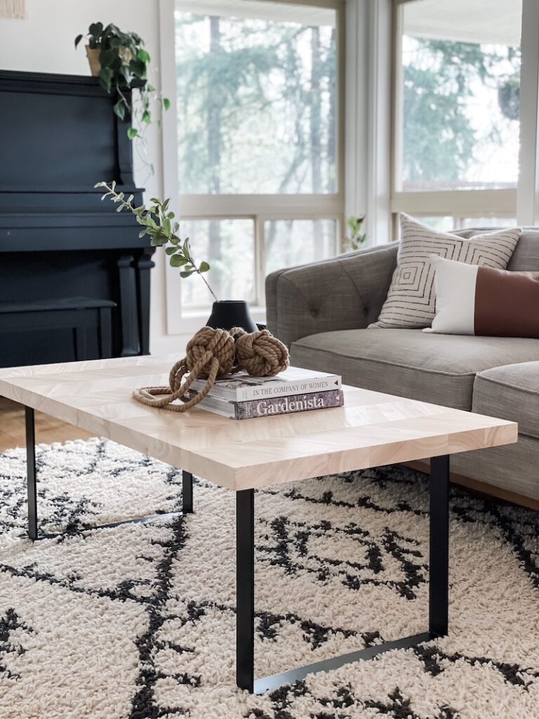 living room coffee table, rug, couch, and black piano