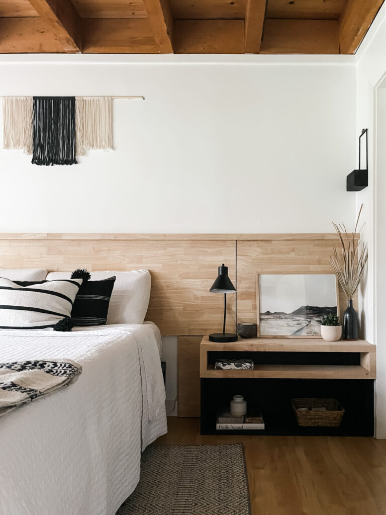 bedroom with bed, rug, and artwork