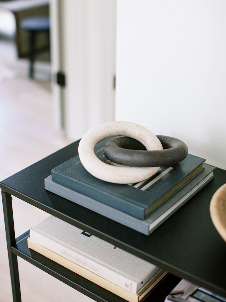 entryway table with books and wood chain