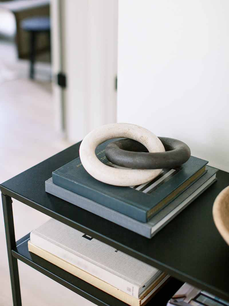 entryway table with books and wood chain