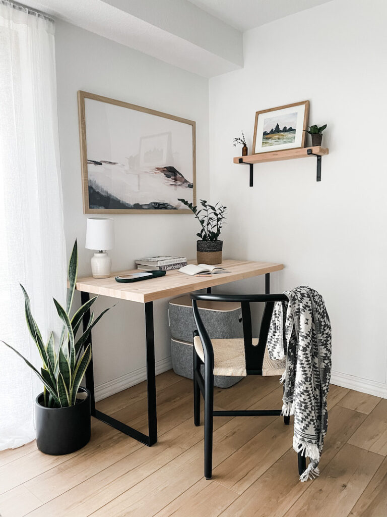 office nook with desk, chair, and artwork