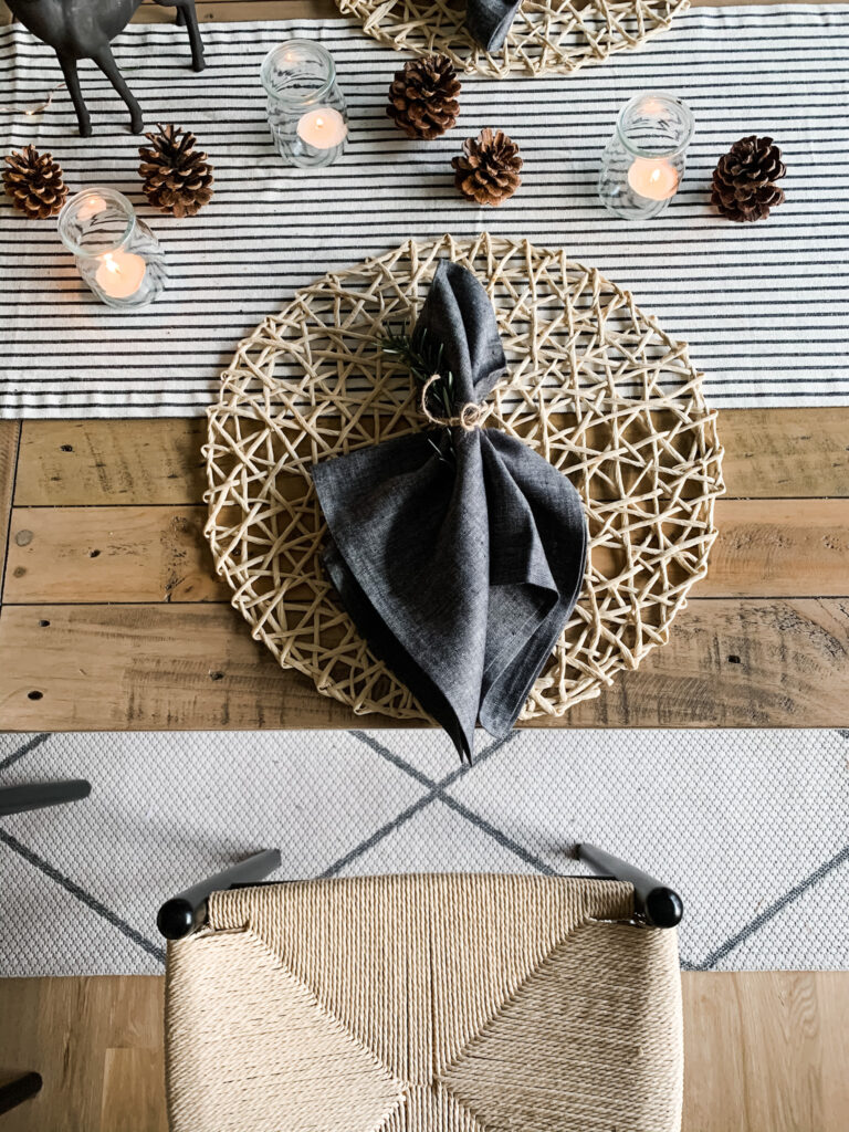 napkins tied with jute string and a sprig of rosemary