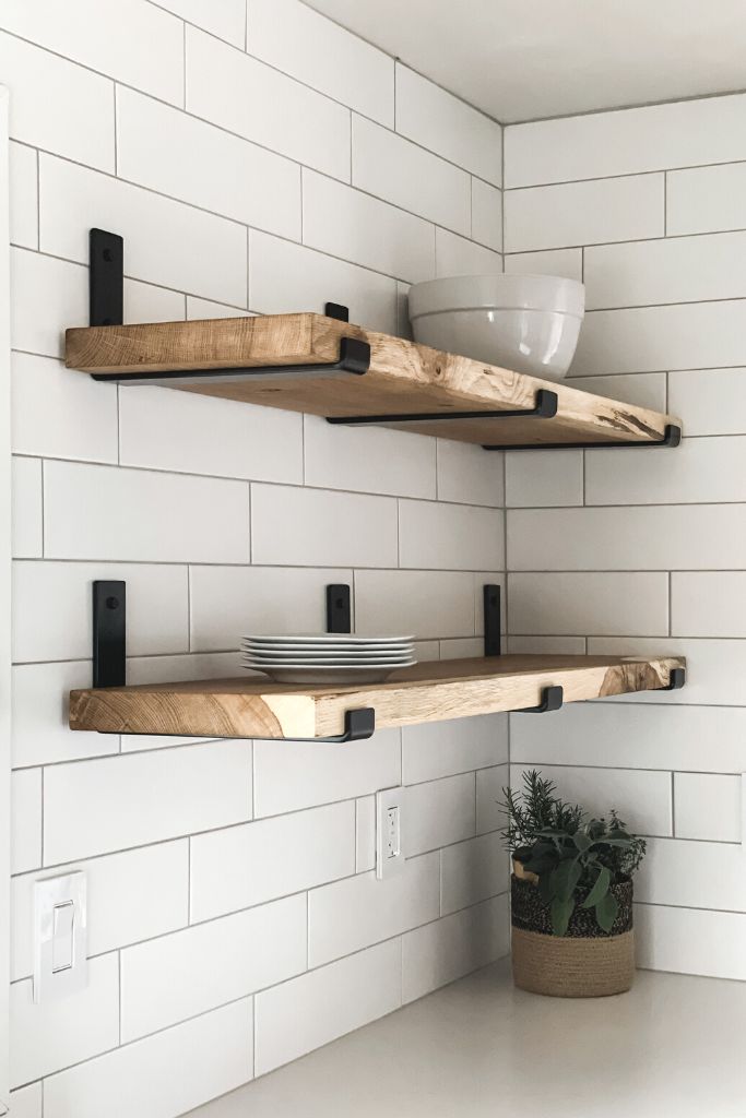 wood shelves in kitchen with white tile backsplash