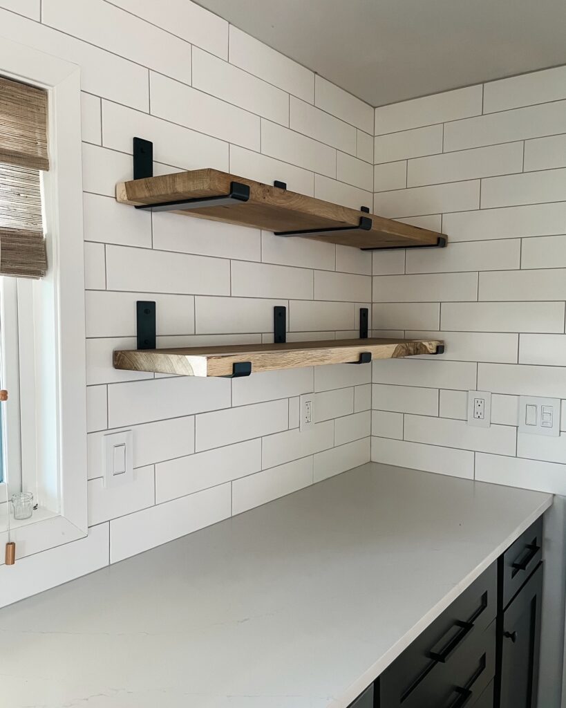 wood shelves in the kitchen with white subway tile