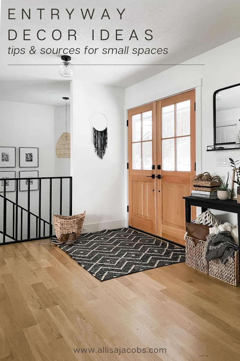 entryway with black rug, baskets, and mirror