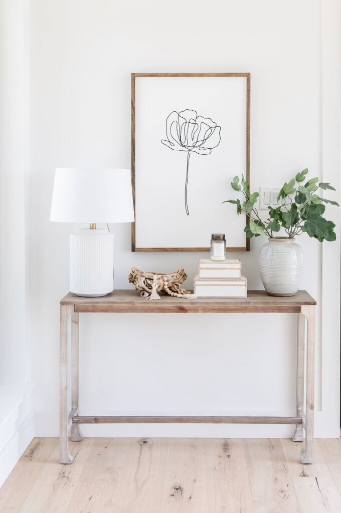 entryway with console table and artwork