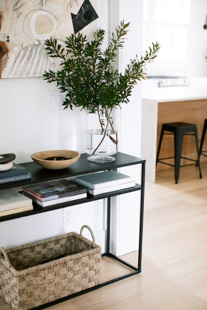 entryway table with decor and plants