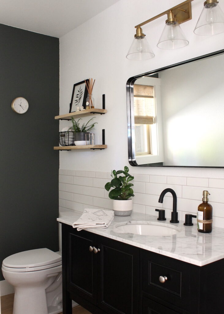 bathroom with dark wall, tile. and wood shelves