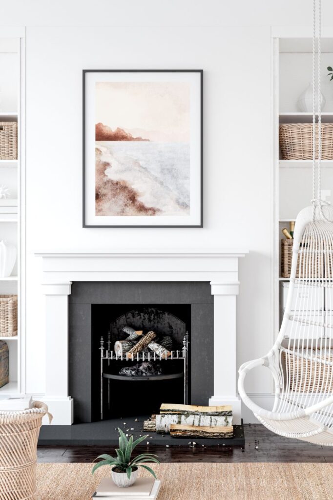 black ans white fireplace with neutral beach art print for vacation rental home