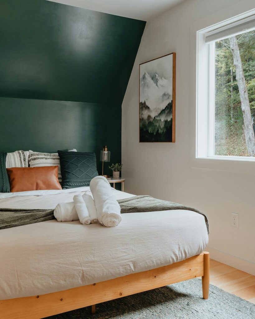 bedroom with dark green accent wall