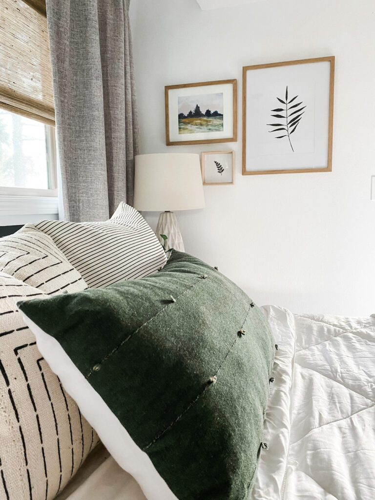 green pillow on bed neutral decor