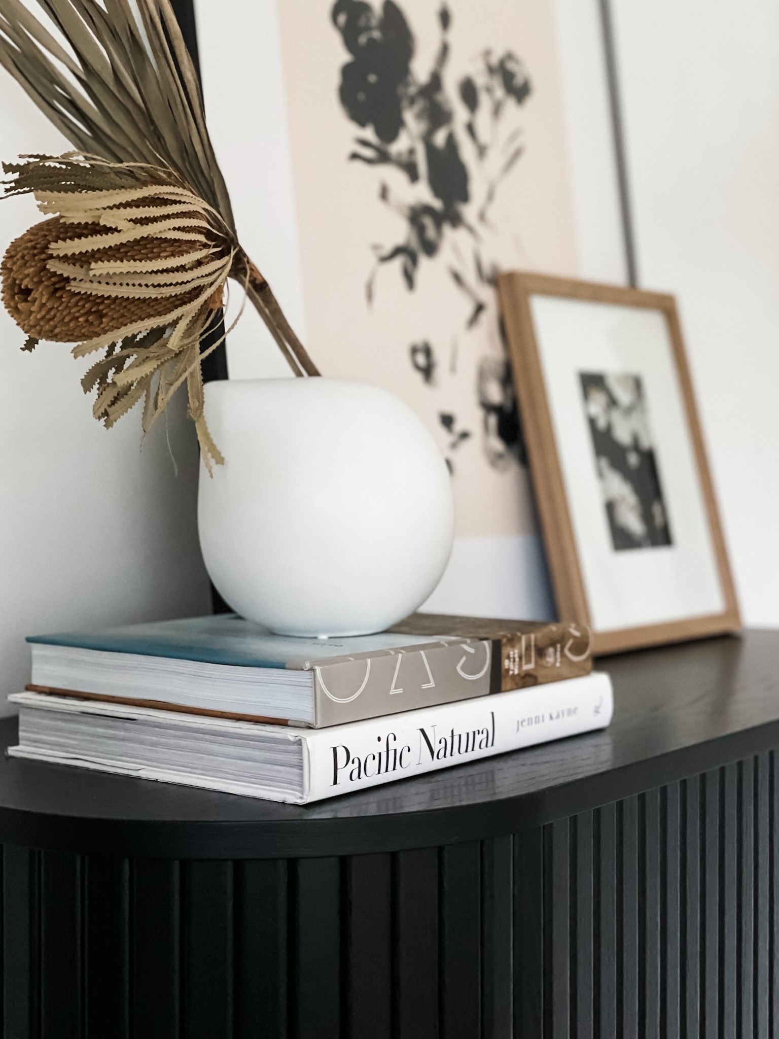 vase with books and artwork