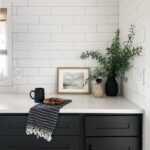 kitchen with black cabinets and white tile backsplash