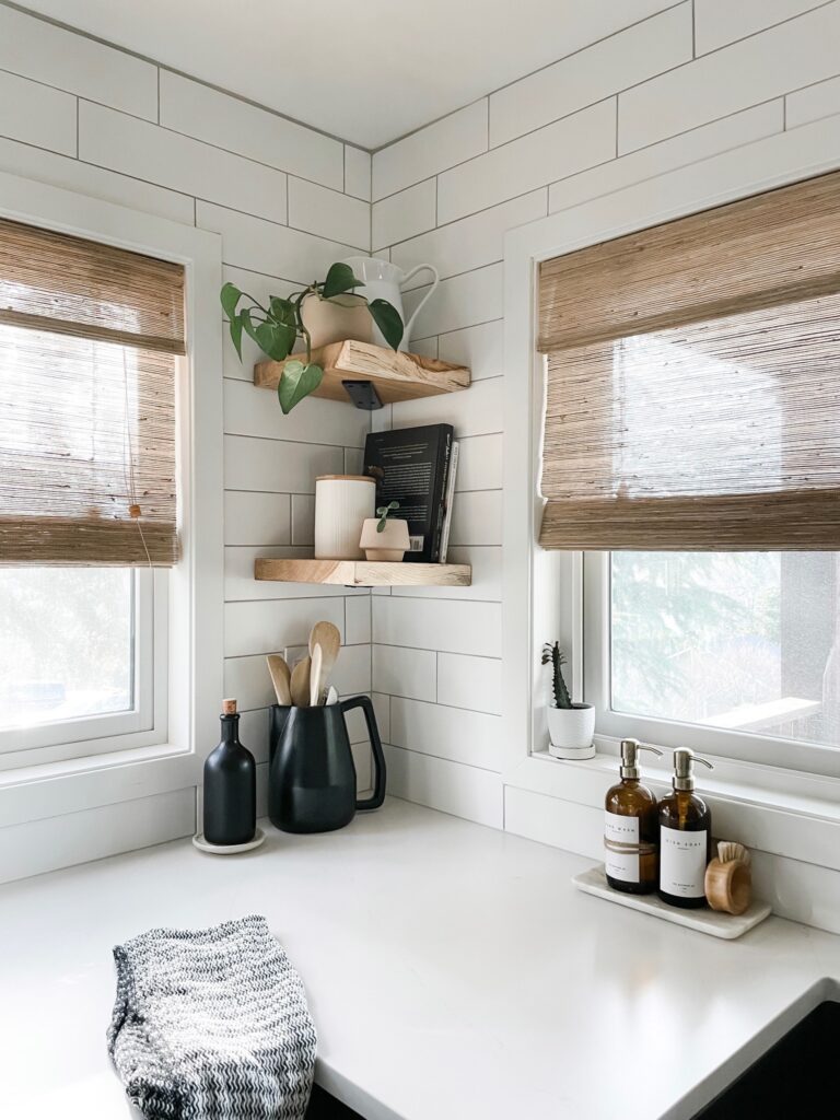 white and black kitchen with wood corner shelves