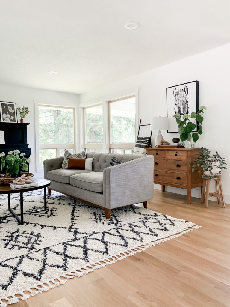 living room refresh with new rug, gray couch, and neutral decor