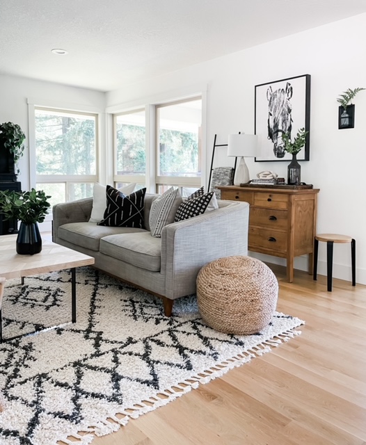 living room couch with throw pillows and neutral decor