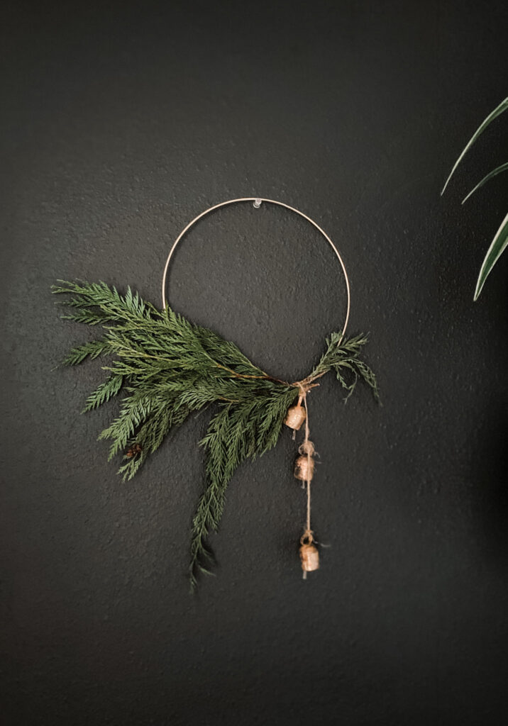 modern christmas wreath made with a gold hoop and fresh greenery