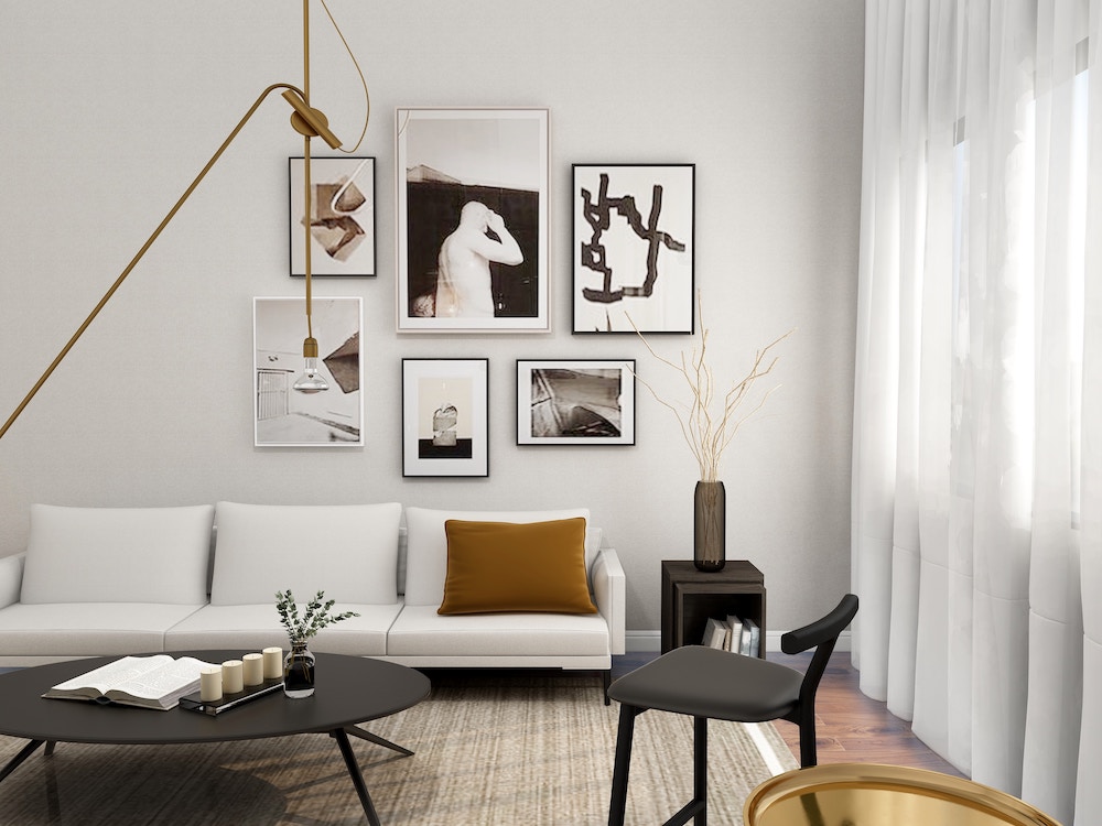 modern living room with abstract art, neutral colors, and black decor