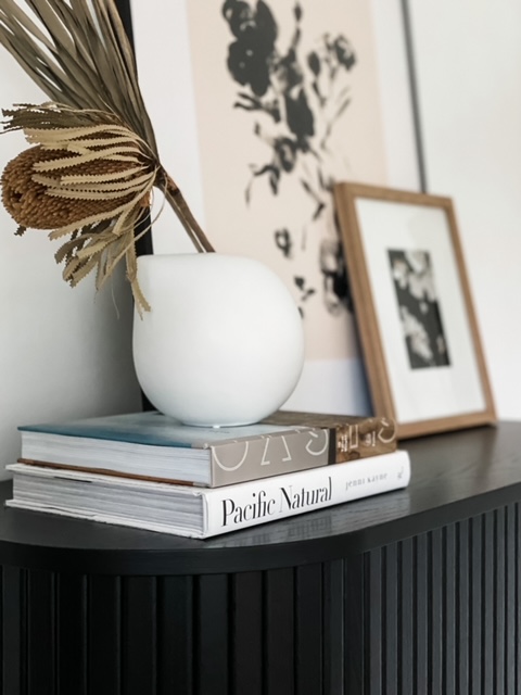 books, vase, and artwork