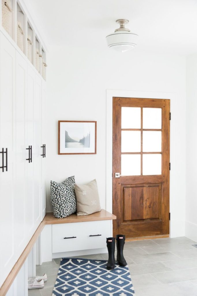 mudroom with pretty details like door, tile and light