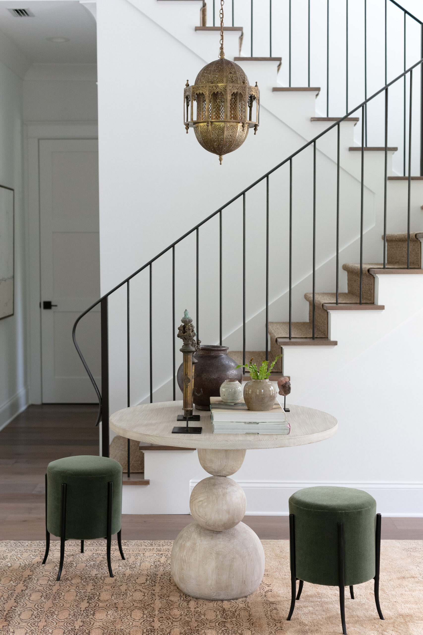 entryway with white walls and metal railing