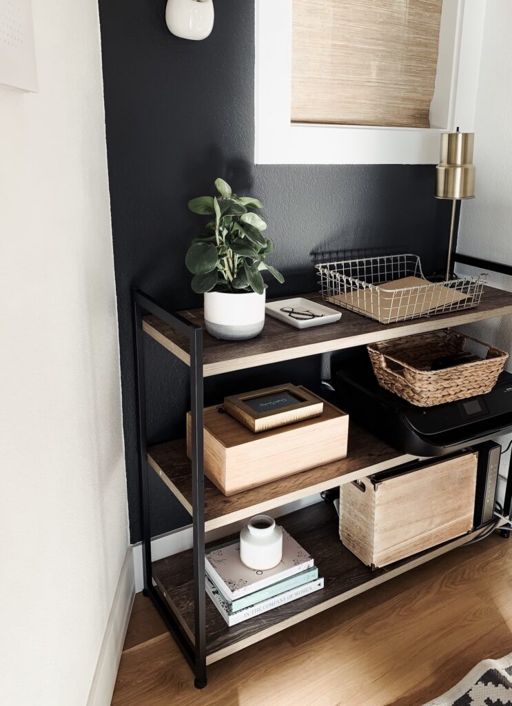office bookshelf with books, files, boxes, baskets, and printer
