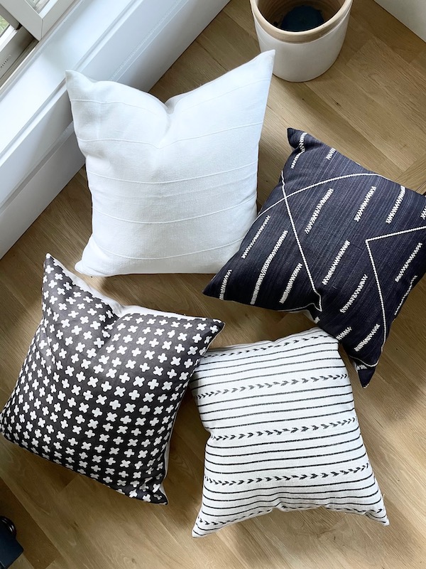 four neutral pillow covers on wood floor from etsy