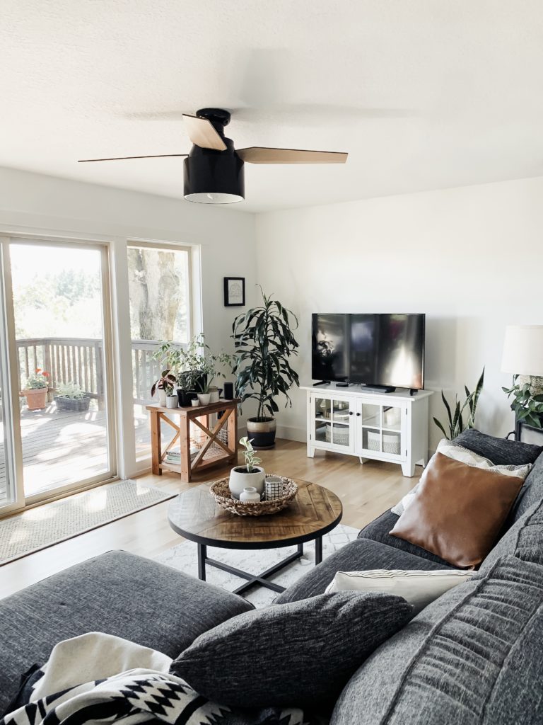 remodeled living room with white walls, wood, and neutral accents