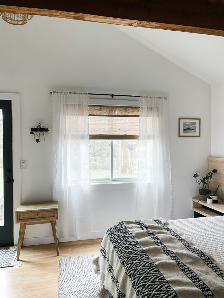 bedroom with window treatments and blanket