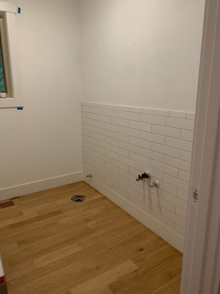 white subway tile half wall in bathroom