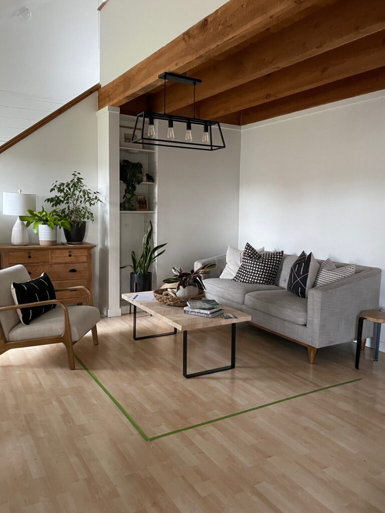 using painter's tape to lay out rug size in living room