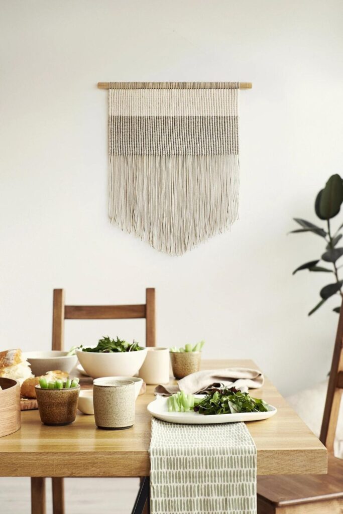 textile wall hanging in dining room