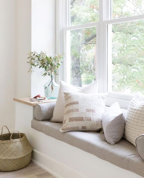 pretty reading nook with soft and muted textiles